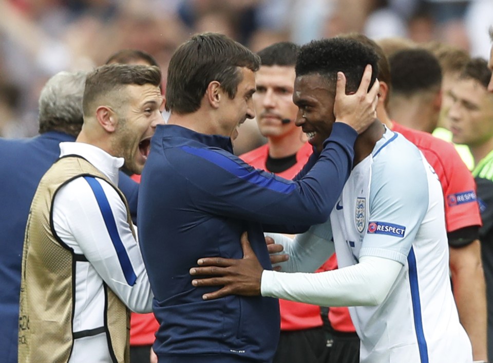 Gary Neville and Jack Wilshere celebrate with Daniel Sturridge after his late winner sealed victory over Wales