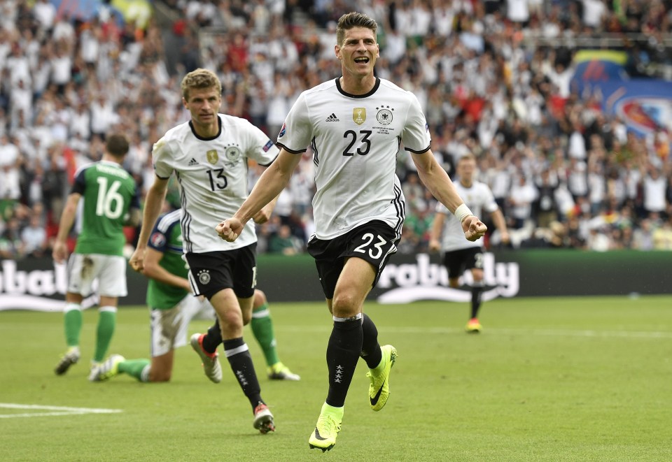 Germany's Mario Gomez celebrates after scoring the opening goal during the Euro 2016 Group C soccer match between Northern Ireland and Germany at the Parc des Princes stadium in Paris, France, Tuesday, June 21, 2016. (AP Photo/Martin Meissner)