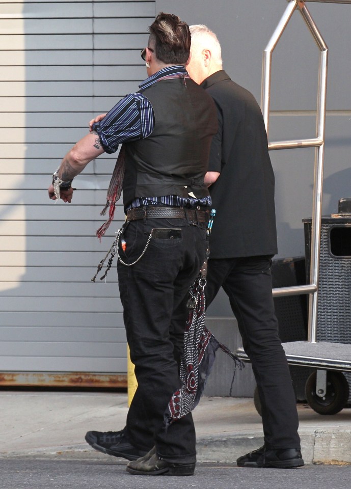 Johnny heads off into the night as he gets set to take the stage with his band 