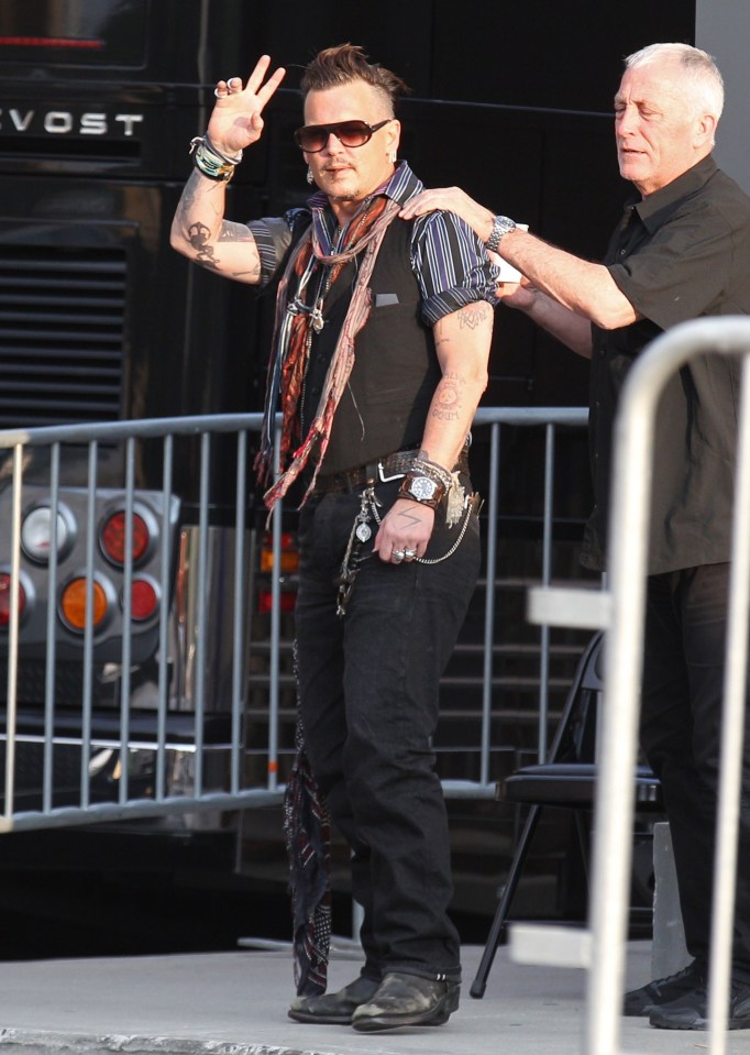 Peace out! The actor and singer offers up a conciliatory sign as he heads backstage 