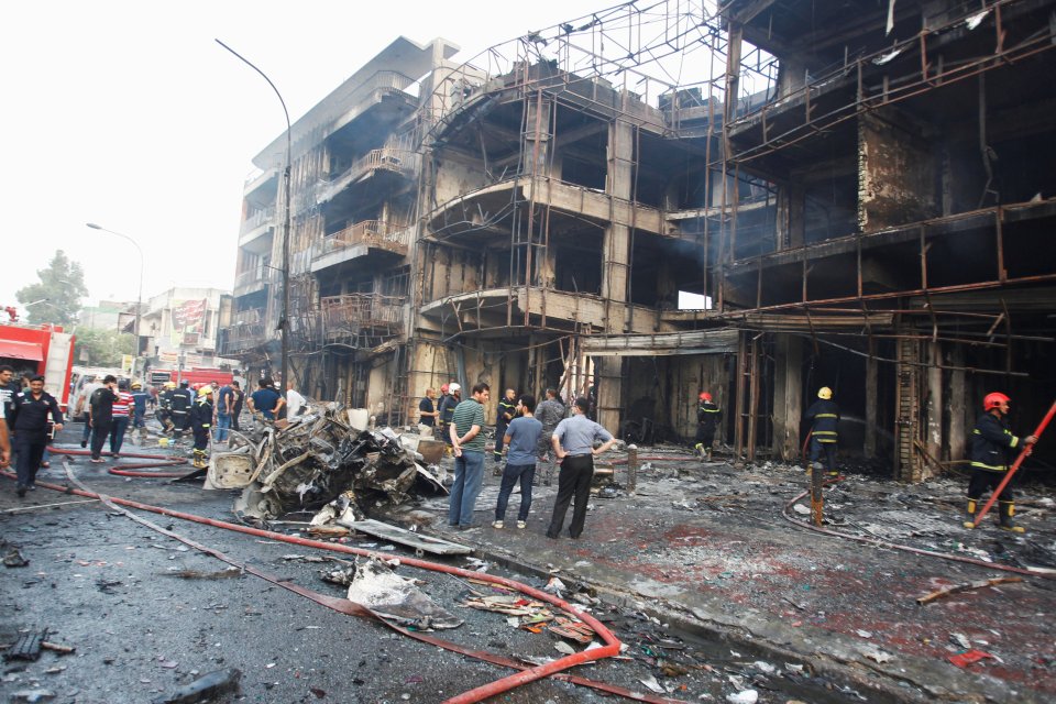 Crowds gather in the destroyed area today where bodies were still being cleared