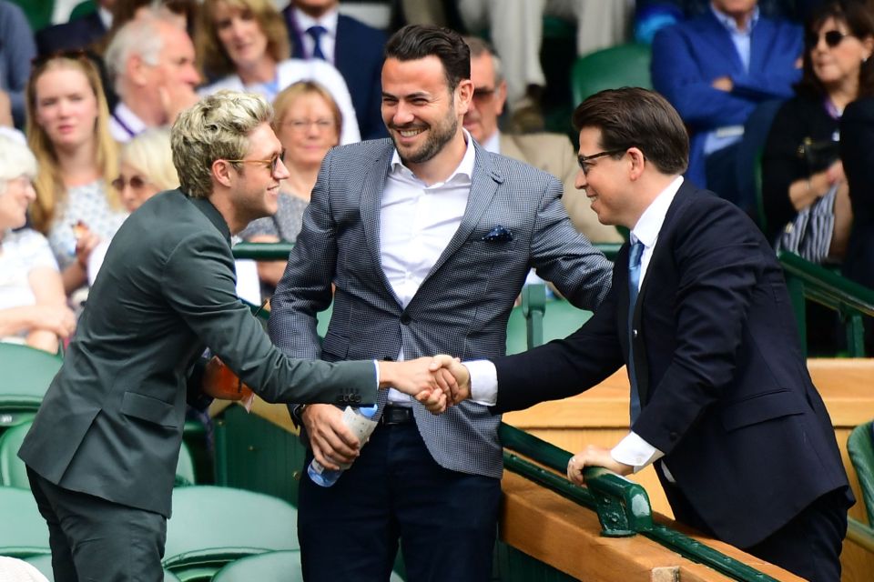 One Direction star Niall Horan (L) shake