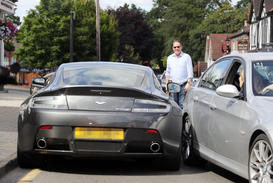 He roped in a passer-by to help him continue forward without dinging the supercar