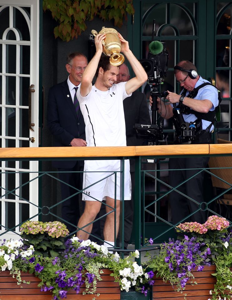 Murray parades the trophy on a centre court balcony