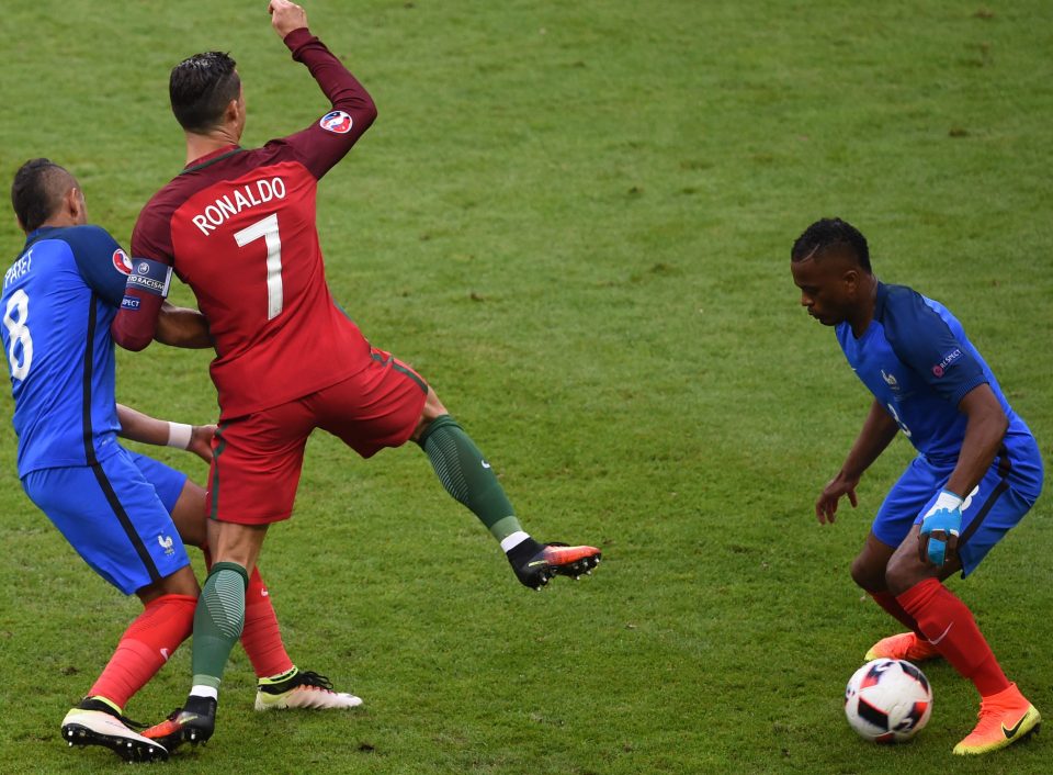 France's Dimitri Payet tackles Portugal's Cristiano Ronaldo,