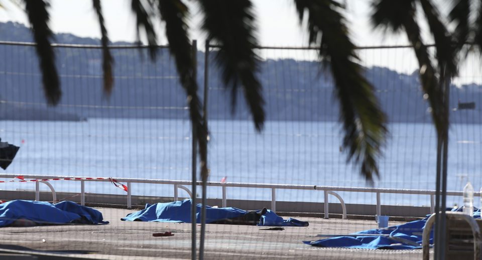 Carnage... bodies of victims are covered by sheets at the scene of a truck massacre in Nice