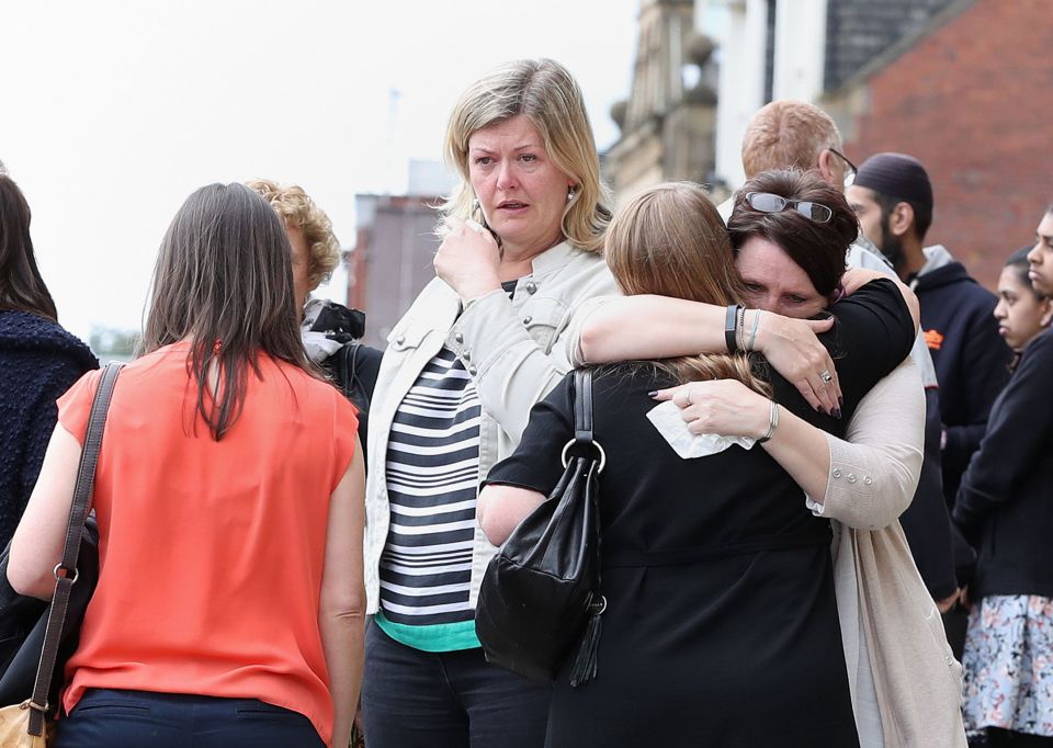Mourners comfort each other with a hug after seeing the Labour MP's coffin for the first time