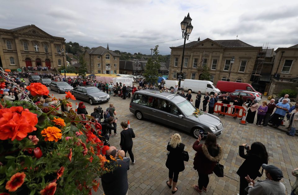 Hearse travels through Batley, as the family of Mrs Cox follow from behind