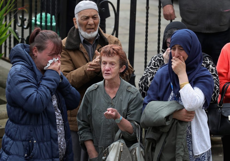 People break down in tears as they see the hearse carrying Jo pass them in the street, a month after her death