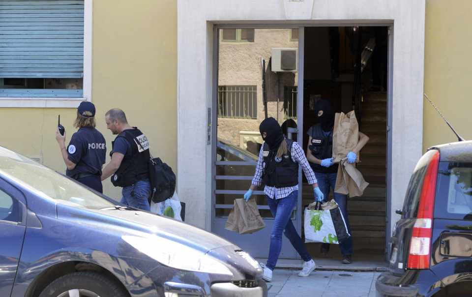 French investigating police carry evidence bags after they conducted a search at the apartment and a truck, the day after a heavy a truck ran into a crowd at high speed killing scores and injuring more who were celebrating the national holiday, in Nice
