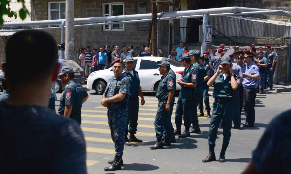 Armenian police create a human barricade as ongoing siege continues