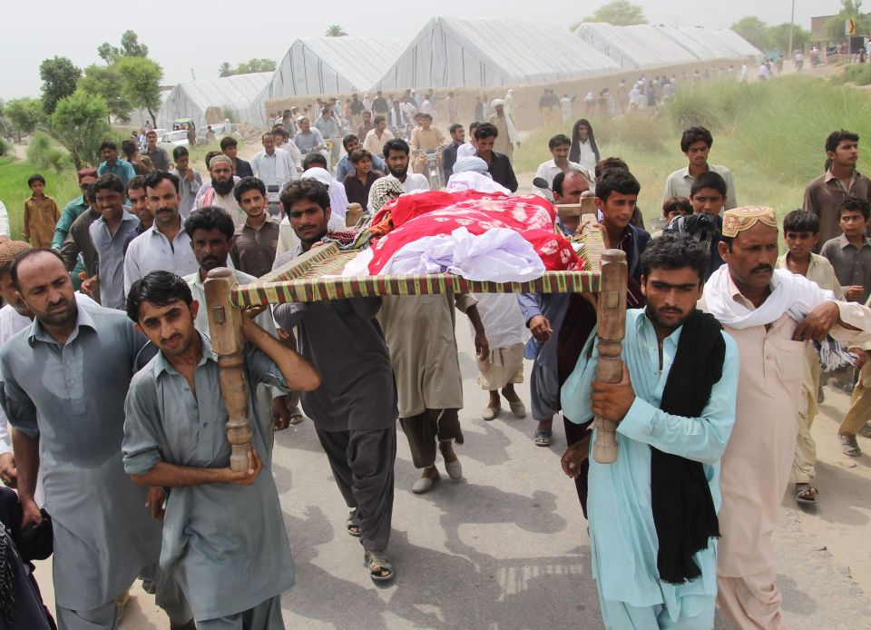 Pakistani relatives and residents carry