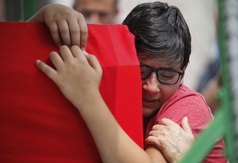 A boy cries over the coffin of his dead dad who got killed in a thwarted coup during a memorial service at Fatih mosque in Istanbul