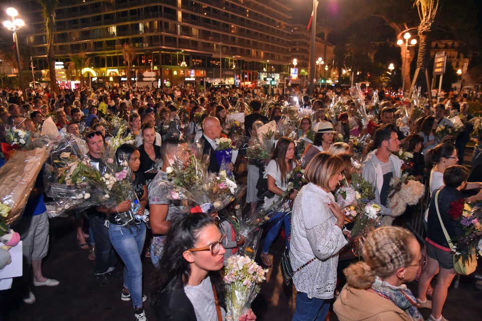 French citizens all pull together to remove the flowers from the Promenade des Anglais before placing them on the seafront in Nice.