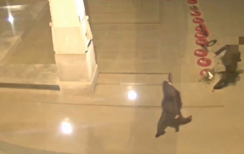Shockingly, the suited man then gives the poppy display a running boot