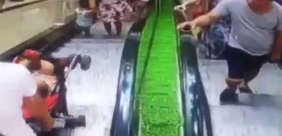 Footage shows the woman wheeling the buggy onto the escalator despite no being allowed 