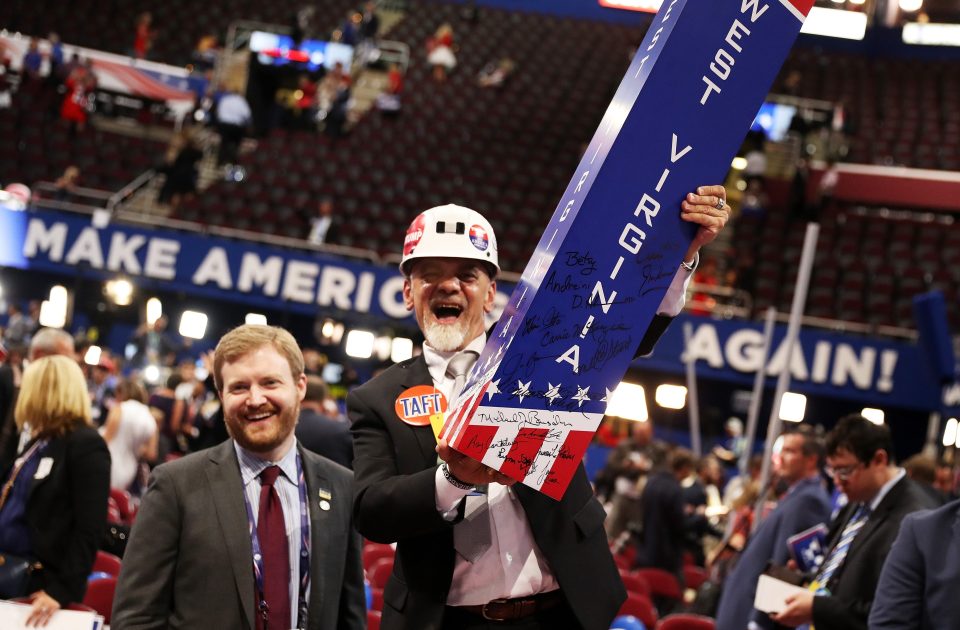 Attendees taking down delegation signage at the end of the fourth day of the convention