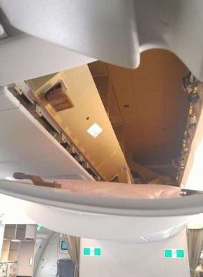 Part of the Cathay Pacific plane's ceiling was pulled off when a passenger thought it was an overhead compartment for bags