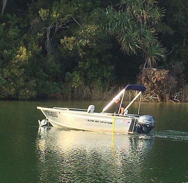 Can you spot what is wrong with this photo of a fisherman driving his boat down the river?