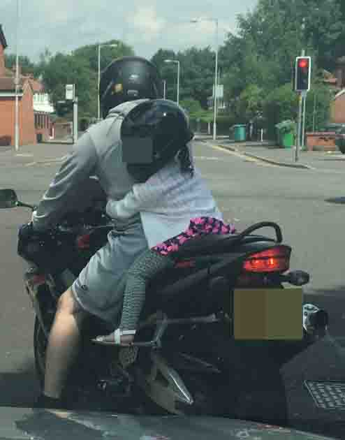 Motorists were astonished after seeing the young girl clinging to the back of the rider of the powerful motorbike