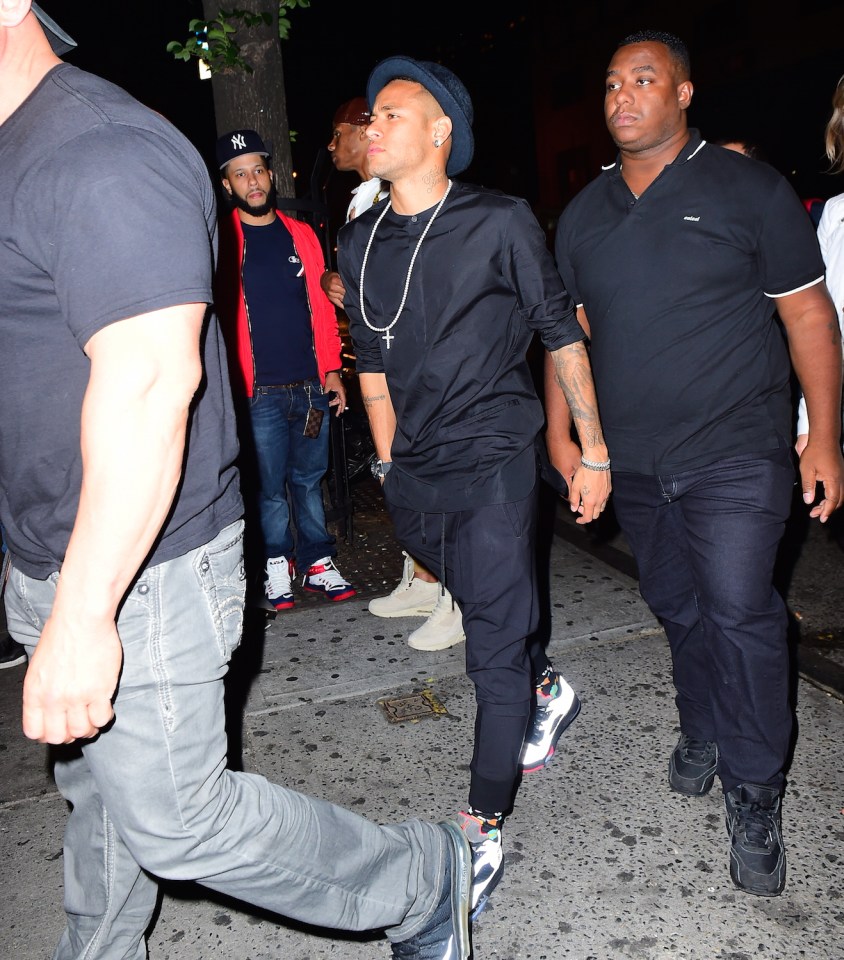 Neymar leaves New York's Up and Down nightclub flanked by bodyguards