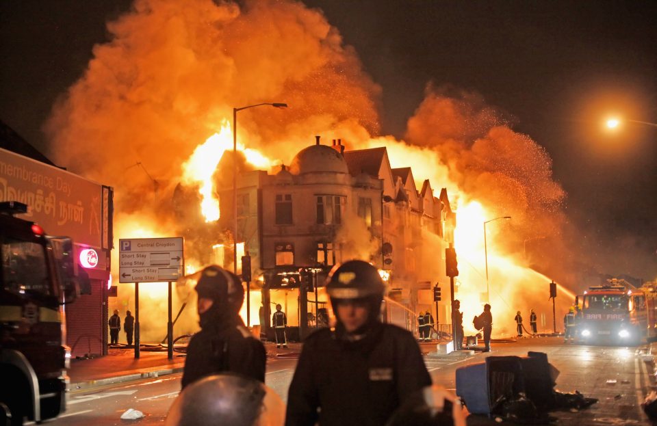 Firefighters battle a large fire that broke out in shops and residential properties in Croydon on August 9, 2011 in London