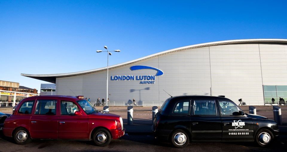 Taxis outside London Luton Airport Terminal building, Luton, Bedfordshire, England, UK