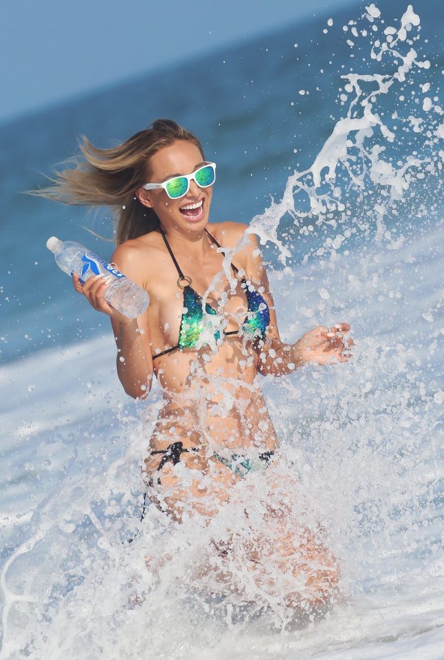 She laughs as she is sprayed by sea water 