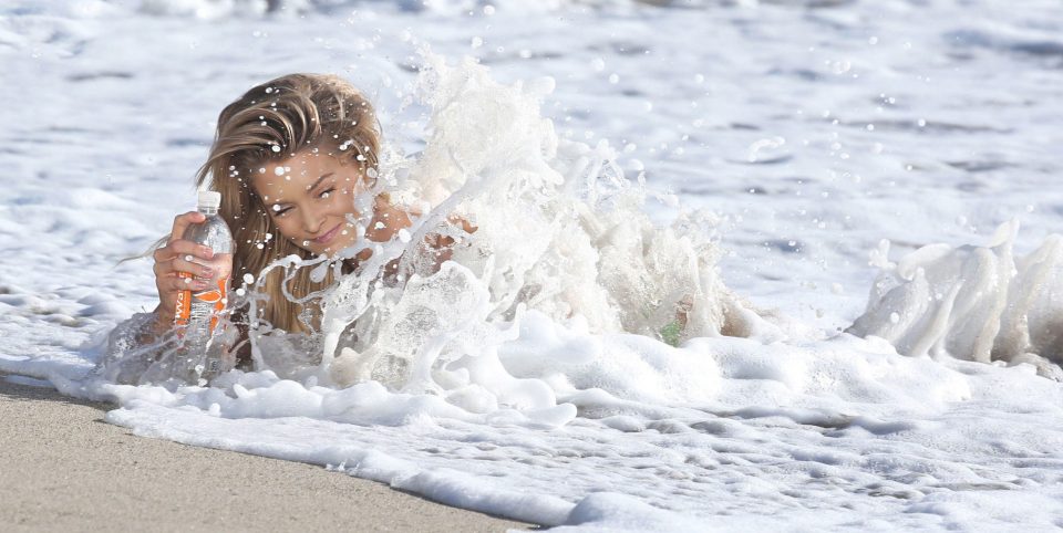 Her shoot in ruined by a massive tidal wave