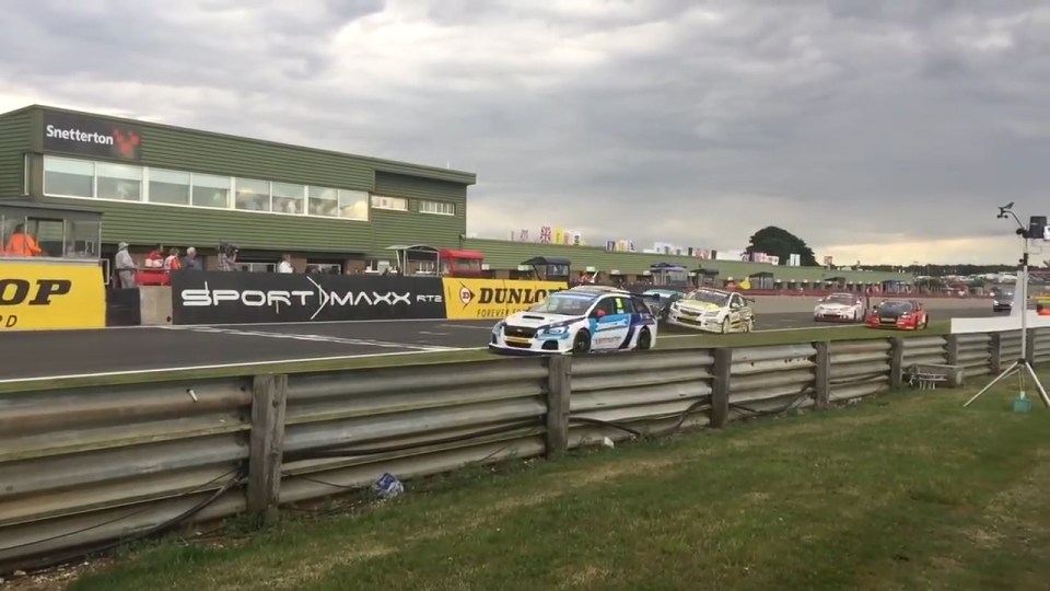 The race car clips another vehicle while barrelling down the track