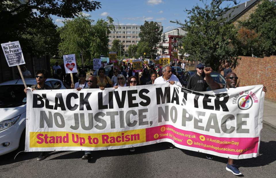 Protesters hold up placards as they marc