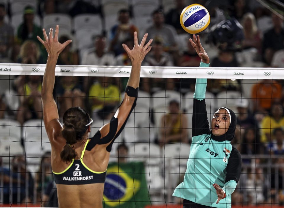 Elgobashy of Egypt (R) spikes the ball against Kira Walkenhorst of Germany (L) during the women's Beach Volleyball preliminary pool D game against Germany