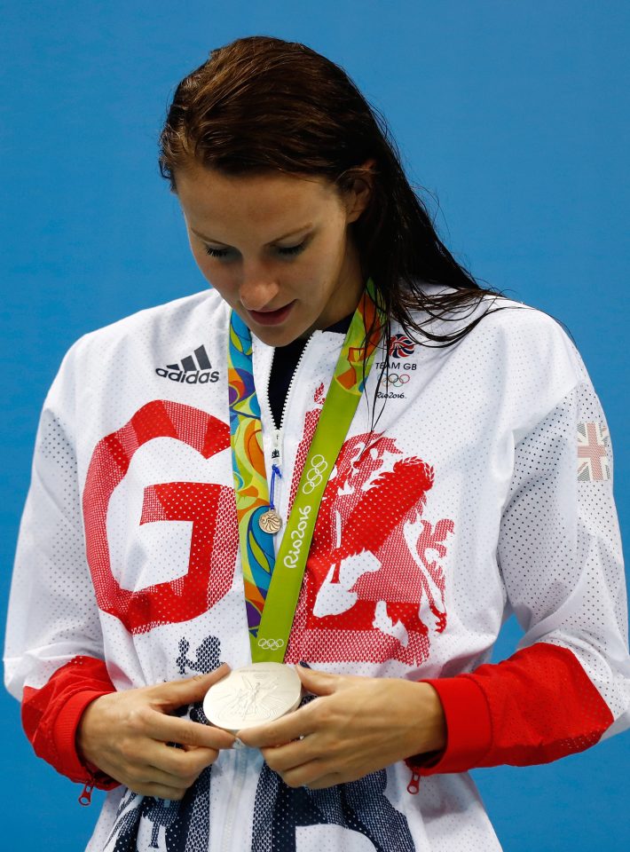 Jazz Carlin takes a close look at her medal on the podium