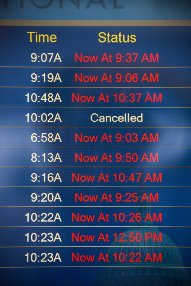An arrival board shows numerous delayed flights after a global computer system outage grounded US airline 'Delta'