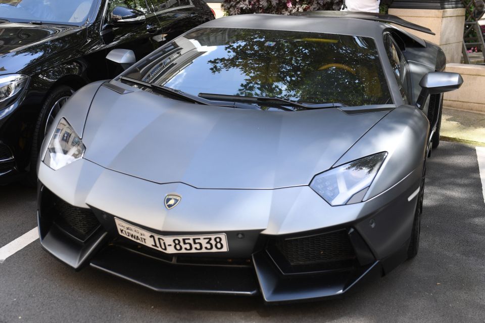 A Lamborghini car with a Kuwaiti number plate is parked by The Dorchester Hotel