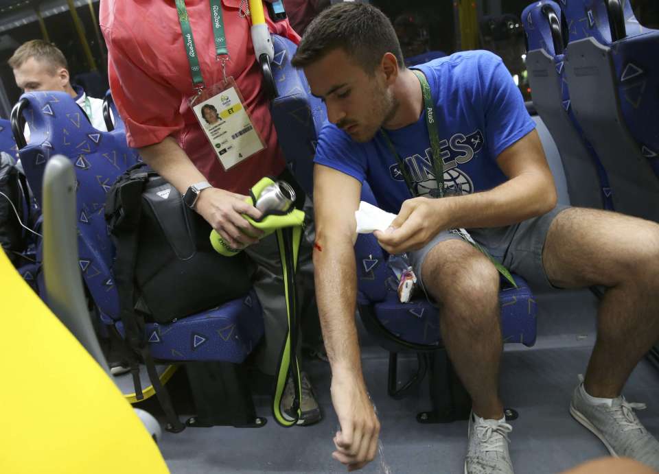 Technician Kaan Korkmaz has water poured on a lesion caused when a window shattered in Rio de Janeiro