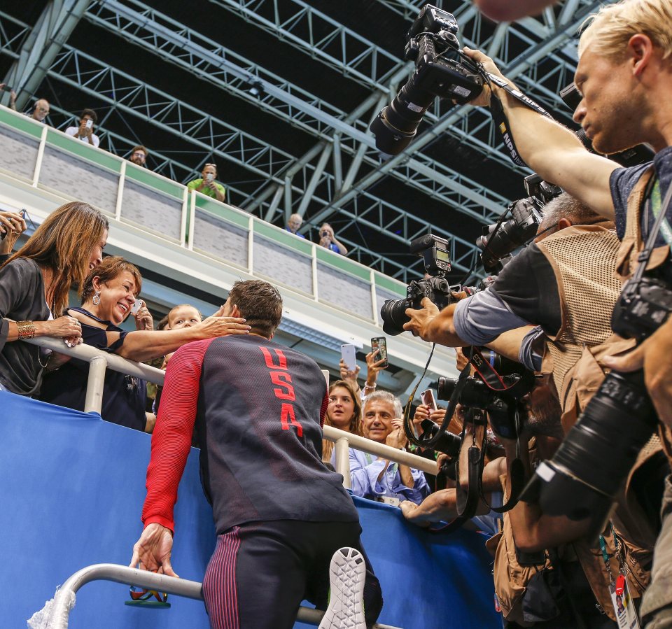 The American meets his mother Deborah (left), his fiancee Nicole Johnson and their son Boomer in the stands at the Aquatics Centre