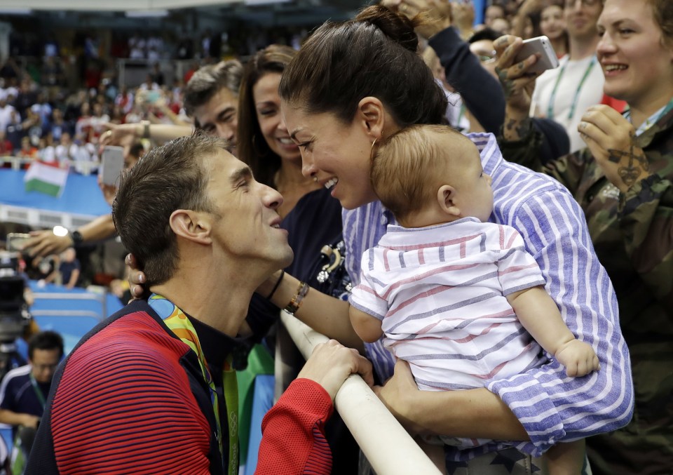 Michael Phelps leans in for a kiss off beautiful fiancee Nicole Johnson