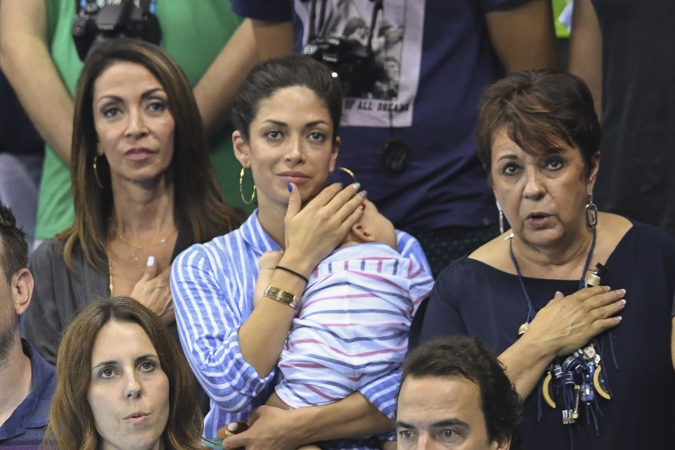 Phelps's fiancee Nicole Johnson sits anxiously with their son Boomer Robert Phelps