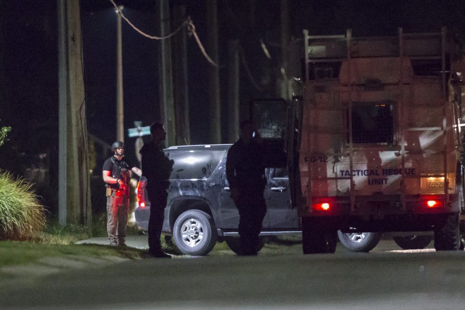Police stood watch out the front of the Ontario home after the suspect was shot dead