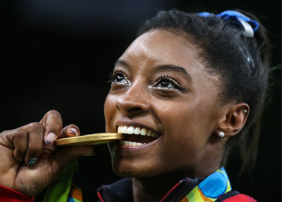 Golden girl Simone Biles takes a bite out of her medal