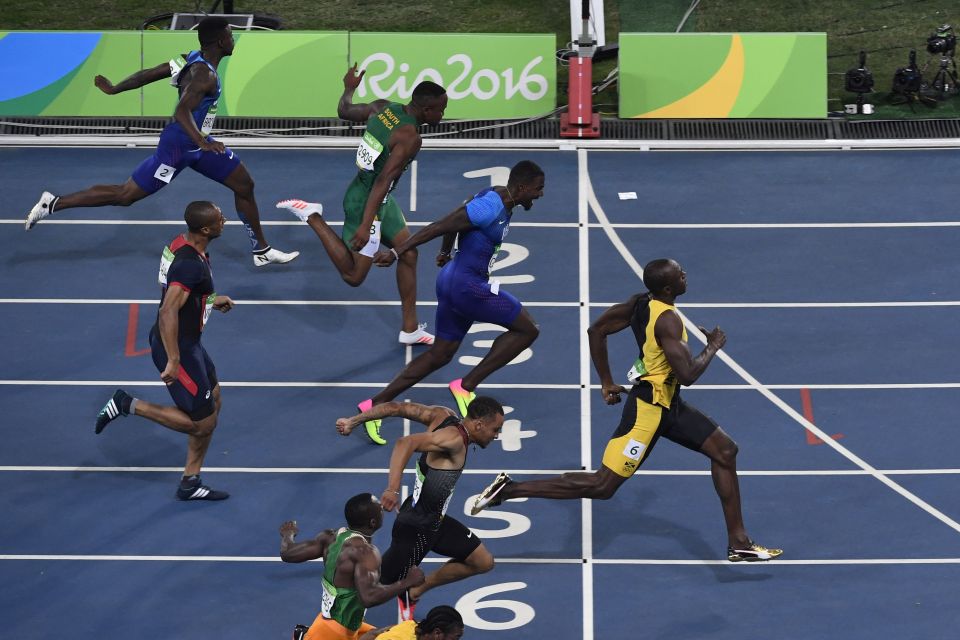 Jamaica's Usain Bolt (R) crosses the fin