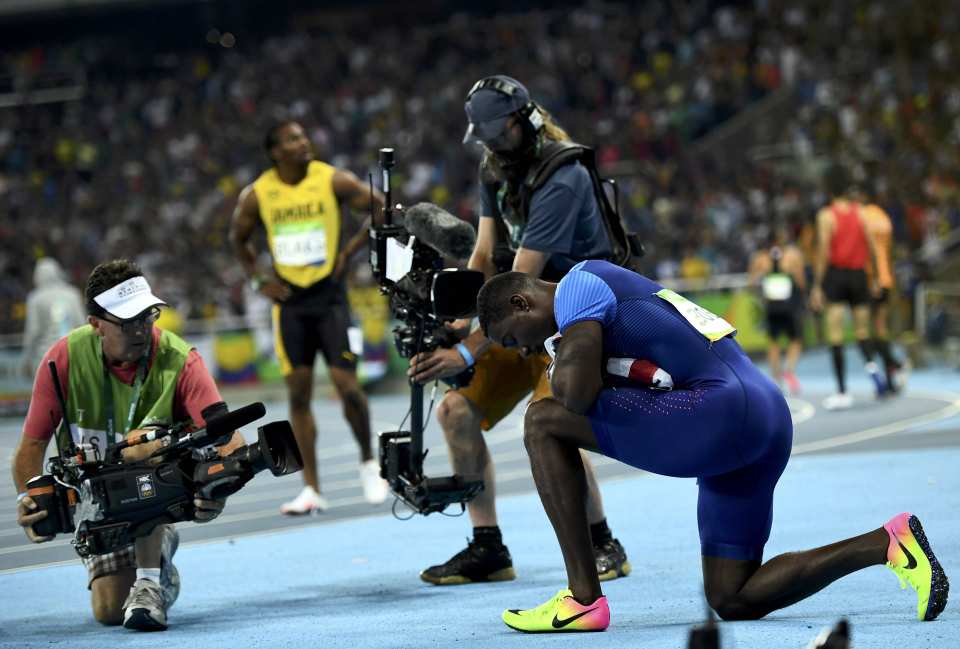 Justin Gatlin kneels down after taking the silver medal in the 100 metres final