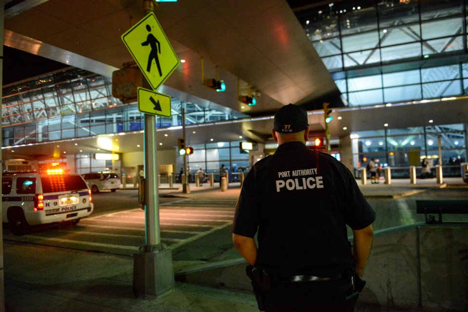 A police officer stands guard at John F. Kennedy airport amid the gunman scare