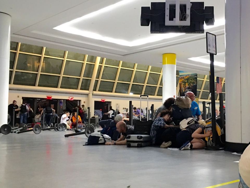 Passengers cower as armed police swarm through the airport