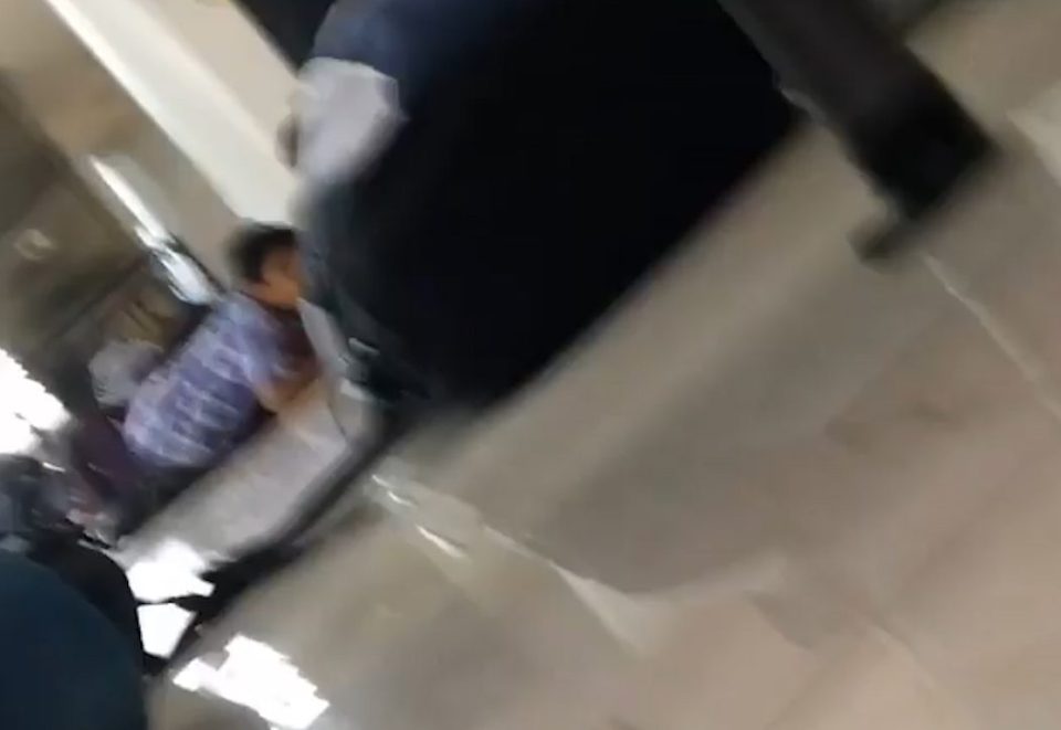 A man is seen lying on the airport floor in this dramatic picture