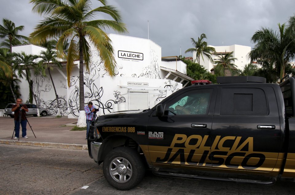 A police vehicle sits parked outside the scene of the incident