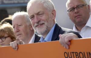 Corbyn forced to sit on train carriage floor after backing strikes by rail workers