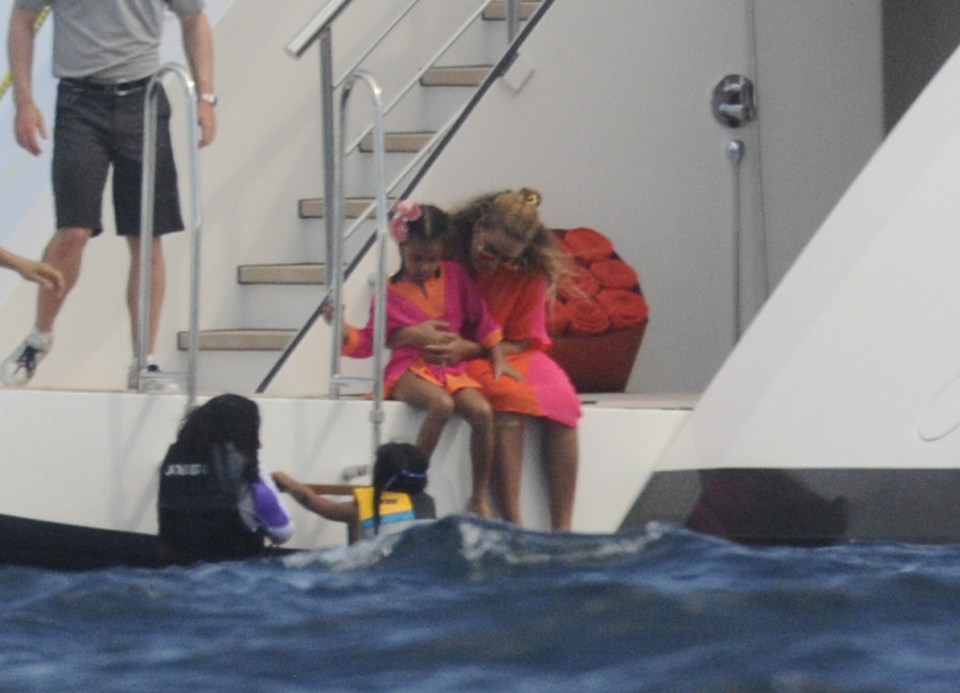 Mother and daughter paddle and test the waves