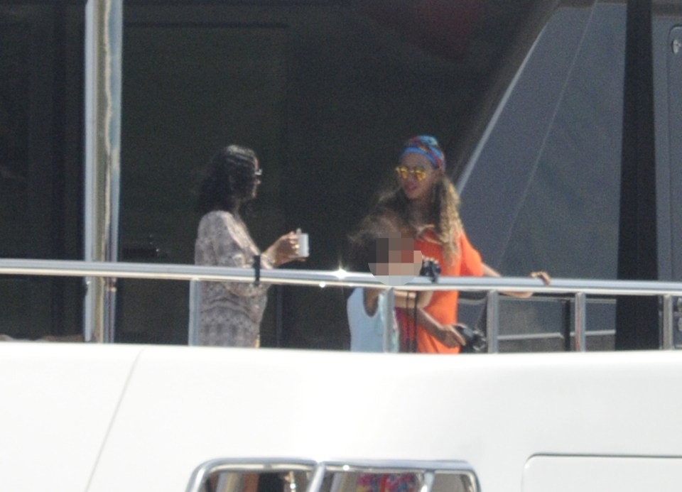 Beyonce looks on as Jay jet skis below